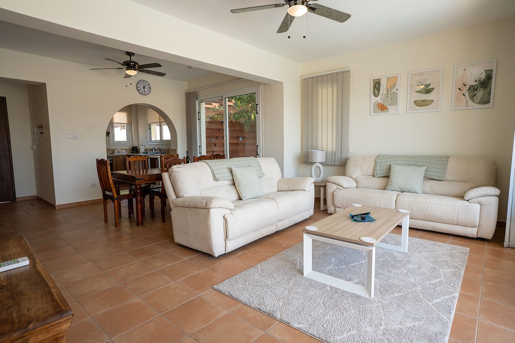 Spacious living room with cream sofas and coffee table