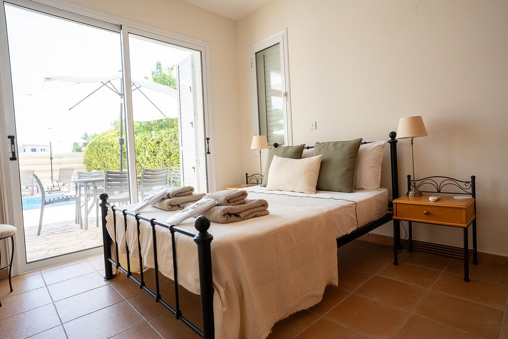 Bedroom with patio doors overlooking pool