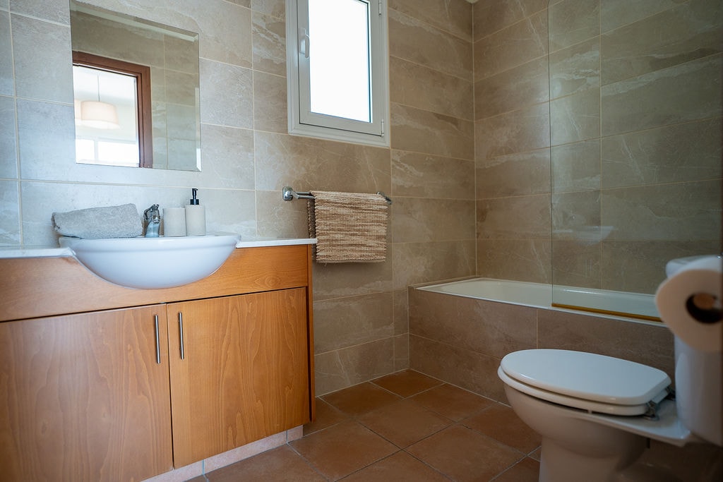 Modern bathroom with wooden vanity and shower