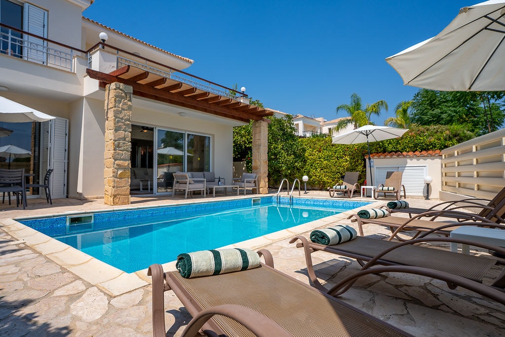 Modern villa with swimming pool and loungers