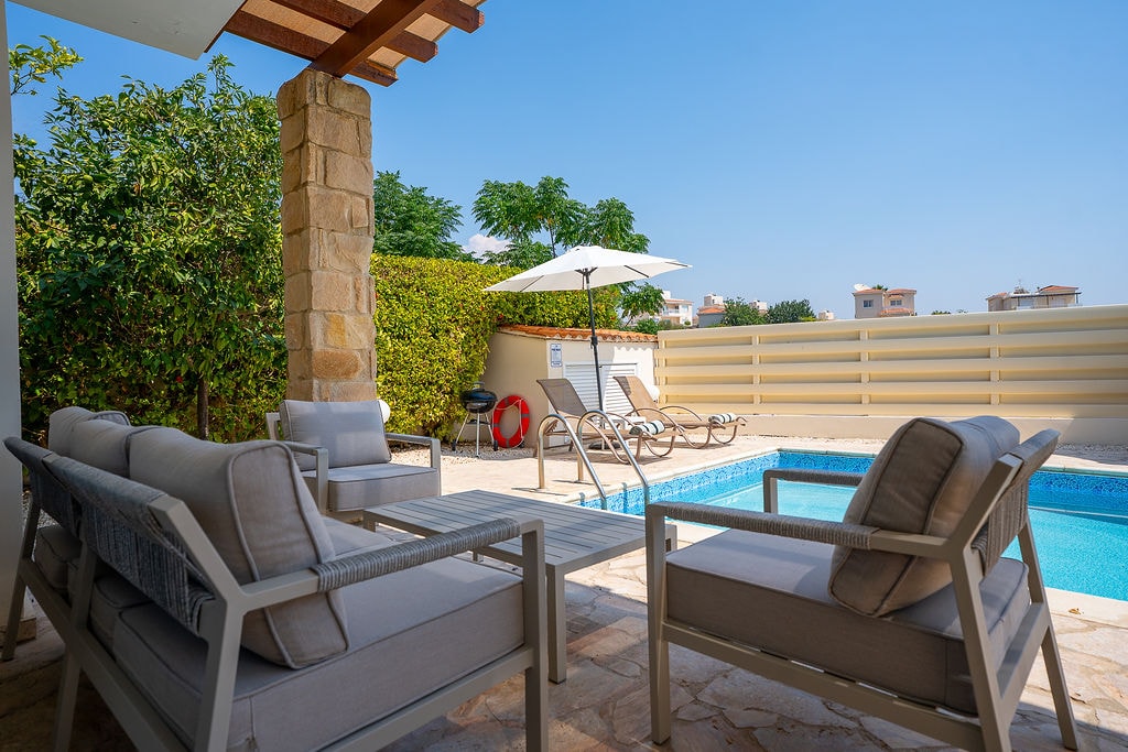 Luxury poolside patio with lounge seating